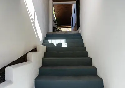 a staircase in a house with blue stairs at Hostel Cocos B&B in Alajuela City
