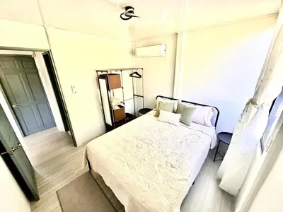 a small bedroom with a bed and a mirror at Piyiyo House 5 minutes from the beach walking in Uvita