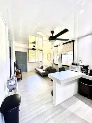 a kitchen and living room with a white counter top at Piyiyo House 5 minutes from the beach walking in Uvita