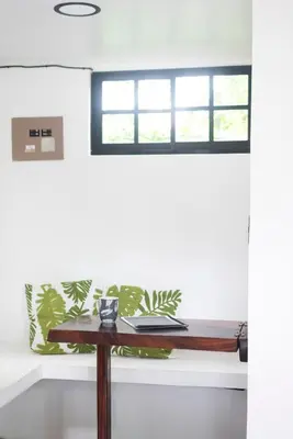 a table in a room with a window at Minicasita Blanca in Uvita