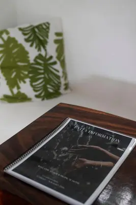 a book sitting on top of a wooden table at Minicasita Blanca in Uvita