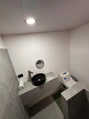 a bathroom with a sink and a toilet at Minicasita Blanca in Uvita