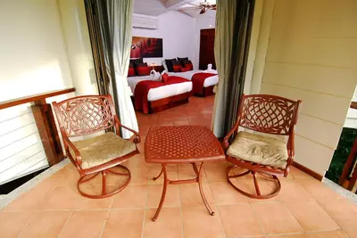 a living room with two chairs and a couch at Tulemar Resort in Manuel Antonio
