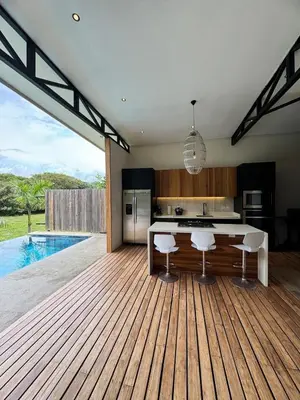 a kitchen with a table and a swimming pool at Tropical House Relaxation with Private Pool in Santa Cruz