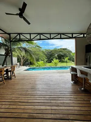 an empty patio with a view of a swimming pool at Tropical House Relaxation with Private Pool in Santa Cruz