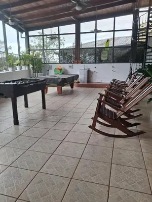 a room with a ping pong table and chairs at The cheap bed, by Natural Pacific Suites in Tapantí
