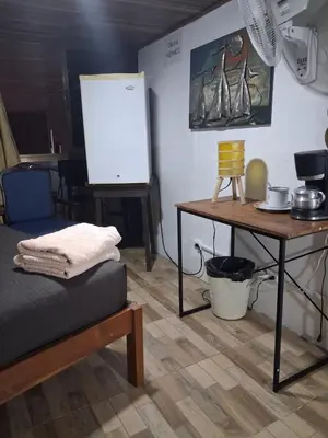 a room with a bed and a table and a whiteboard at The cheap bed, by Natural Pacific Suites in Tapantí
