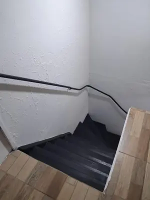 a staircase in a corner of a room at The cheap bed, by Natural Pacific Suites in Tapantí