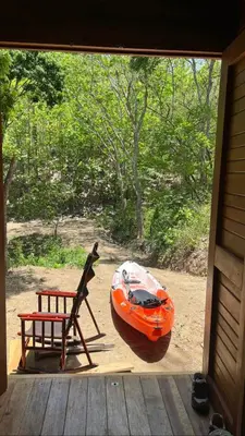an orange kayak and a chair on a porch at Casa Carao Peninsula de Nicoya - front beach