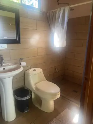 a bathroom with a toilet and a sink at Casa Carao Peninsula de Nicoya - front beach