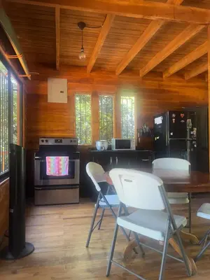 a kitchen with chairs and a table and a television at Casa Carao Peninsula de Nicoya - front beach