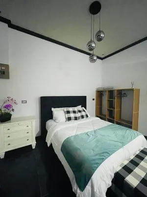 a bedroom with a large bed and a dresser at Cozy and Central Apartment in Alajuela, Perfect for Families in Alajuela City
