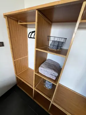 a wooden book shelf in a room at Cozy and Central Apartment in Alajuela, Perfect for Families in Alajuela City