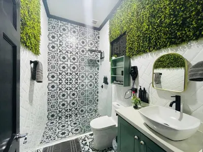 a bathroom with a sink and a toilet and a mirror at Cozy and Central Apartment in Alajuela, Perfect for Families in Alajuela City