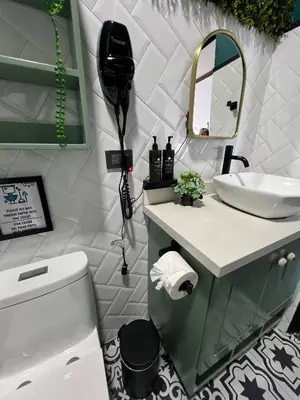 a bathroom with a sink and a toilet and a mirror at Cozy and Central Apartment in Alajuela, Perfect for Families in Alajuela City