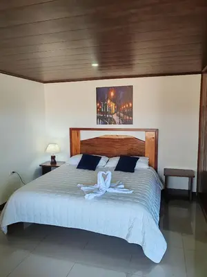 a bedroom with a large bed with a towel on it at Apartamentos Casa Don Luis in Monteverde Costa Rica