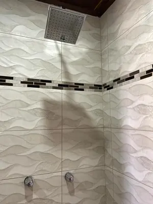 a bathroom with a shower with a laptop on it at Apartamentos Casa Don Luis in Monteverde Costa Rica