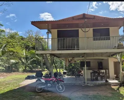 a motorcycle parked in front of a house at Cabaña Las Vegas de Acosta in San Ignacio