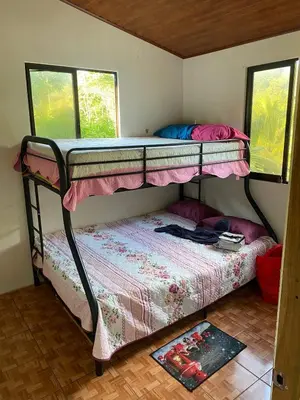 a bedroom with two bunk beds and a rug at Cabaña Las Vegas de Acosta in San Ignacio