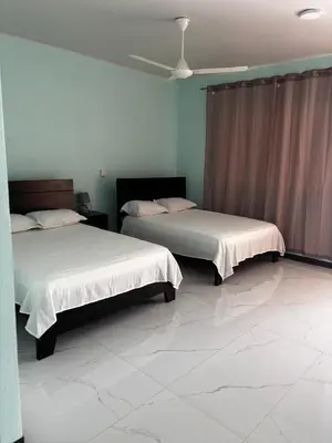 a room with two beds and a ceiling at Cabinas Vif Guanacaste