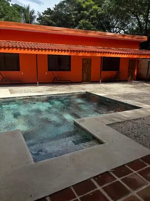 a large pool of water in front of a building at Cabinas Vif Guanacaste