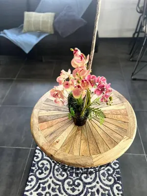 a vase of pink flowers sitting on a wooden table at 5 min from AirPort SJO OASIS LOFT in Alajuela City