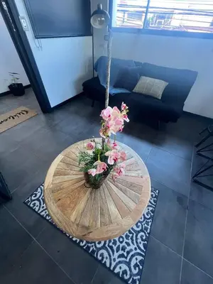 a table with flowers on it in a living room at 5 min from AirPort SJO OASIS LOFT in Alajuela City