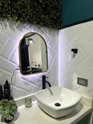 a bathroom with a white sink and a mirror at 5 min from AirPort SJO OASIS LOFT in Alajuela City