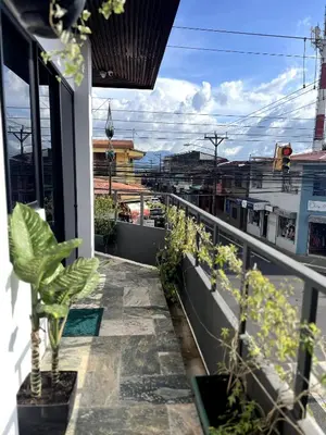 a balcony with potted plants on a building at 5 min from AirPort SJO OASIS LOFT in Alajuela City