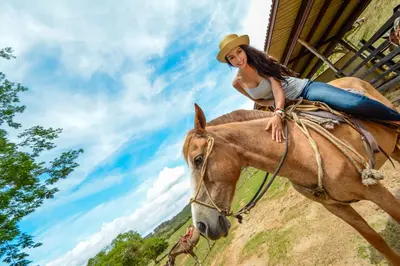 a young woman riding on the back of a horse at Vida Aventura Ranch in Tanques
