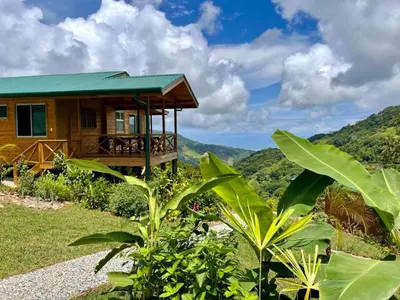 a house on a hill with mountains in the background at El Verde Pacifico in San Luis