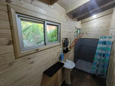 a small bathroom with a toilet and a window at El Verde Pacifico in San Luis