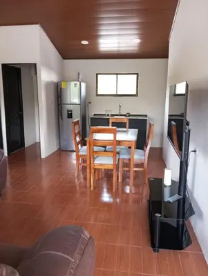 a kitchen and dining room with a table and chairs at Ordoñez in Bijagua