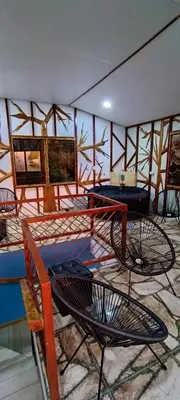 a room with chairs and tables in a room at Four Elements House Peace & Nature in Monteverde in Monteverde Costa Rica