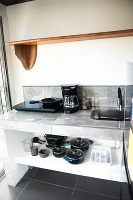 a kitchen counter with a stove top oven at Mini House 2 in Uvita