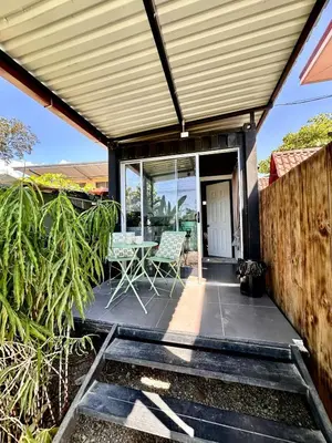 a patio with a table and chairs on it at Mini House 2 in Uvita