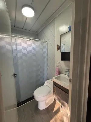 a bathroom with a toilet and a sink and a shower at Casitas Maya in Nicoya