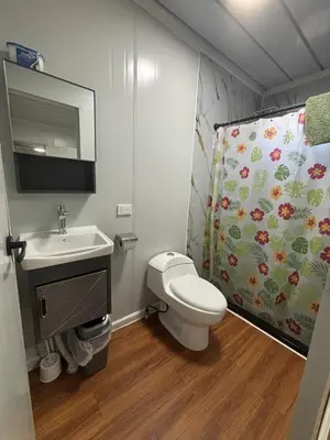a bathroom with a toilet and a sink and a shower curtain at Casitas Maya in Nicoya