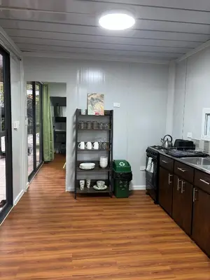 a kitchen with a wooden floor and a counter top at Casitas Maya in Nicoya