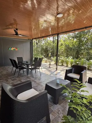 a patio with chairs and tables and a table and chairs at Casitas Maya in Nicoya