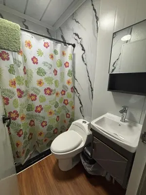 a bathroom with a toilet and a shower curtain at Casitas Maya in Nicoya