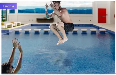 a man jumping into a swimming pool at 1702 Torres los Yoses cozy apartment on the 17th floor with balcony in San José