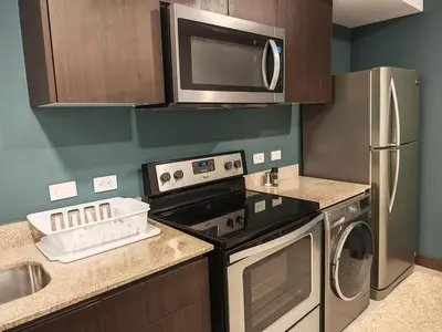 a kitchen with a stove and a refrigerator at 1702 Torres los Yoses cozy apartment on the 17th floor with balcony in San José