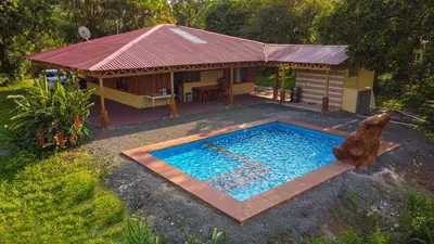 a swimming pool in front of a house at Casa Los Chorros in Agua Azul