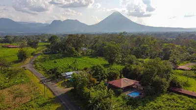 an aerial view of a house with a mountain in the background at Casa Los Chorros in Agua Azul