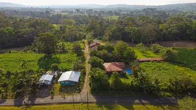 an aerial view of a farm with two trucks in a field at Casa Los Chorros in Agua Azul