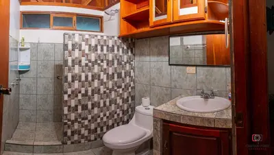a bathroom with a toilet and a sink at Casa Los Chorros in Agua Azul