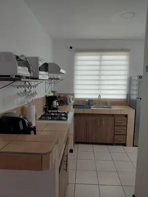 a kitchen with a sink and a stove top oven at Sunset House Herradura in Herradura