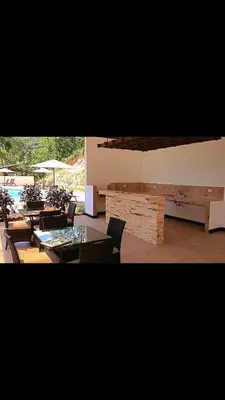 a patio with tables and chairs and a pool at Sunset House Herradura in Herradura