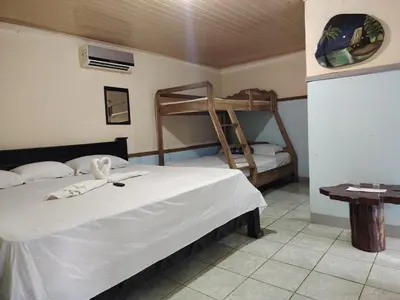 a bedroom with two bunk beds and a table at Vértice Blue Mountain Lodge in San Lorenzo